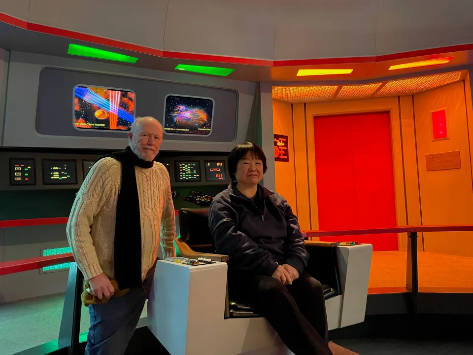 Photograph of the bridge of the original enterprise with the author and his wife.